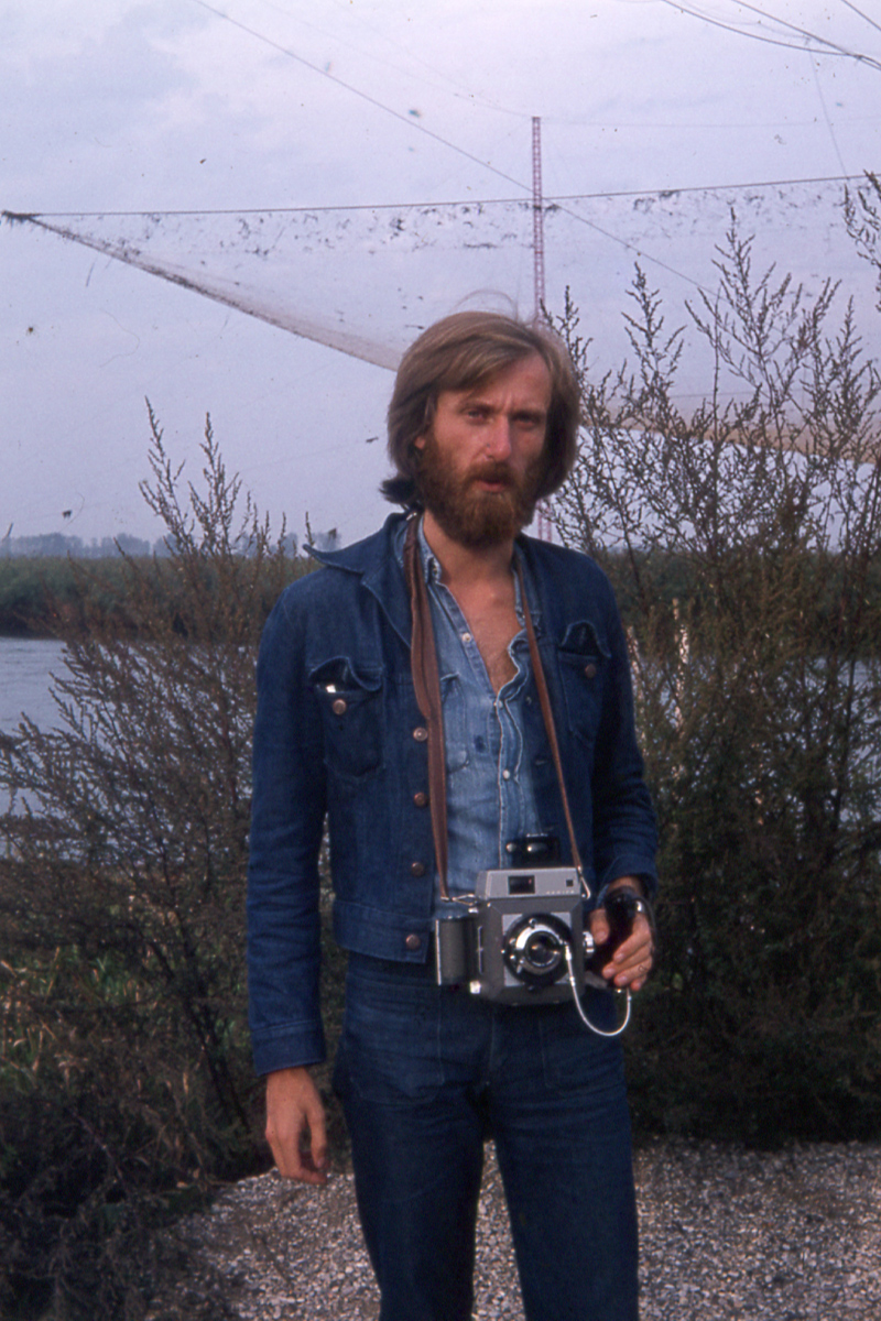 Outdoor portrait of Hans Praetterhoffer holding a camera
