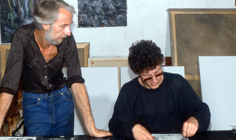 Hans Praetterhoffer and a visitor looking over work at a table