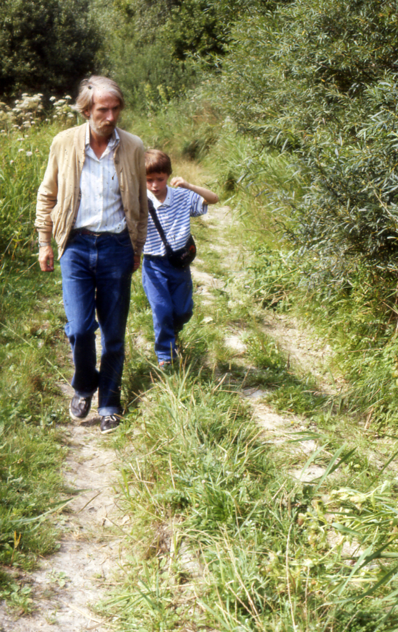 Adult and child walking along a rural path